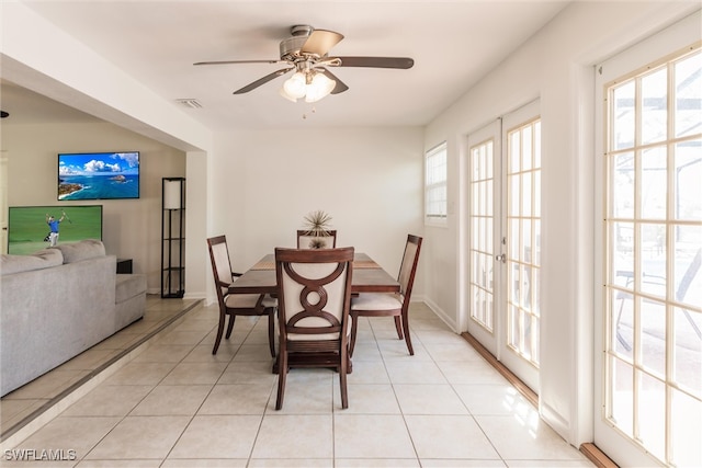 tiled dining area featuring french doors and ceiling fan