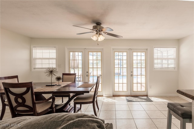 tiled dining area featuring french doors and ceiling fan