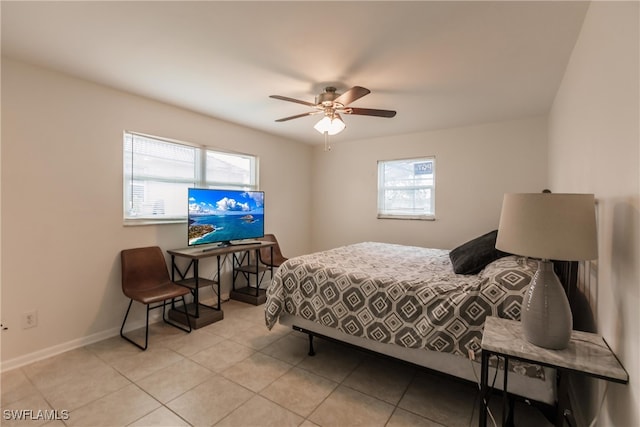 bedroom with multiple windows, light tile patterned floors, and ceiling fan