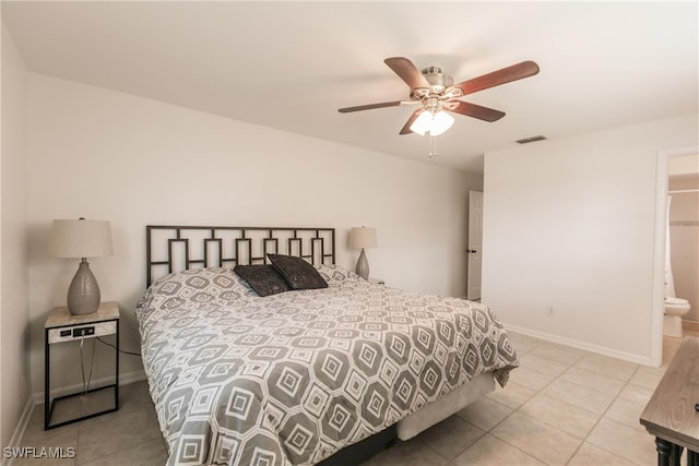 tiled bedroom featuring connected bathroom and ceiling fan