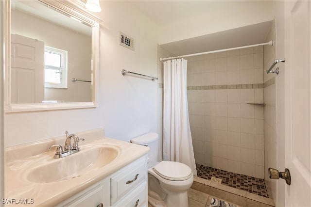 bathroom with vanity, curtained shower, toilet, and tile patterned floors