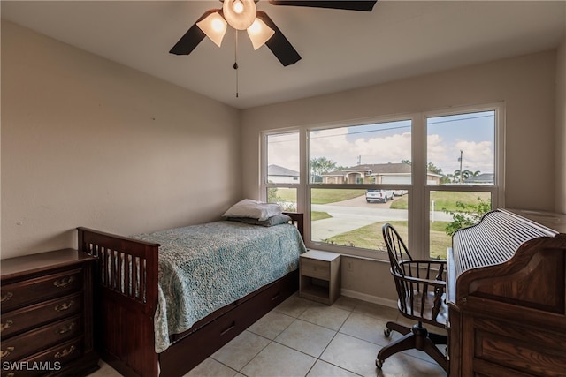 bedroom with ceiling fan, multiple windows, and light tile patterned floors