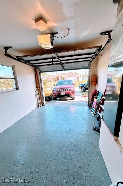 garage with a garage door opener and a carport