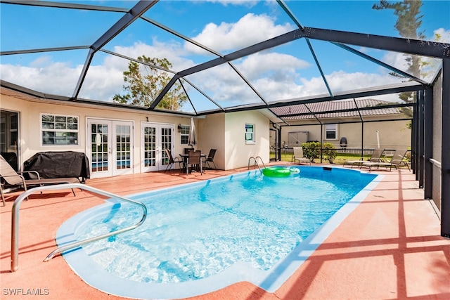 view of swimming pool with french doors, a patio area, a lanai, and a grill