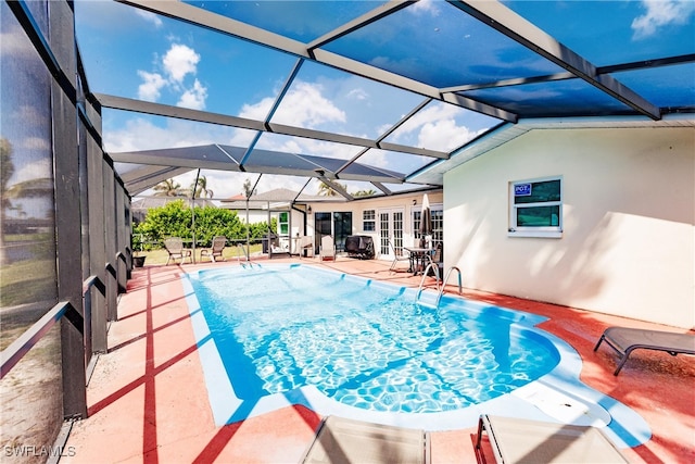 view of swimming pool featuring a patio area and a lanai