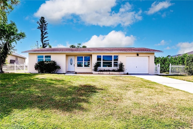 ranch-style house featuring a front yard and a garage