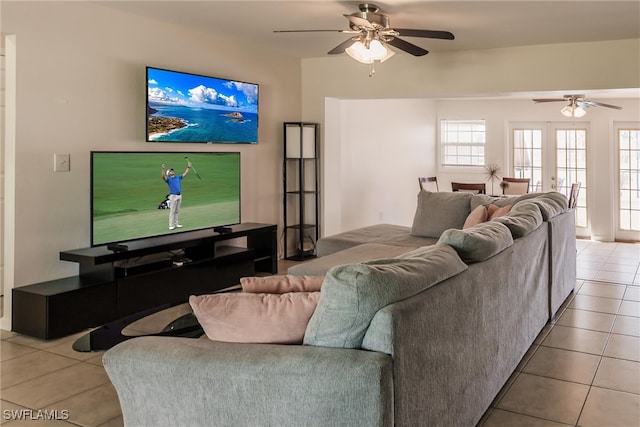 tiled living room featuring french doors and ceiling fan