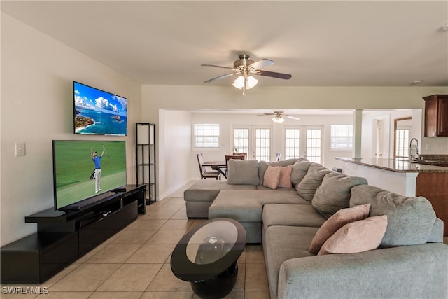 tiled living room with ceiling fan