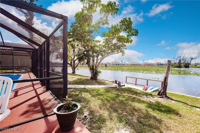 view of dock with a water view, a lanai, and a lawn