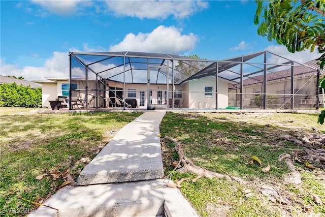 back of property featuring a patio and a lanai