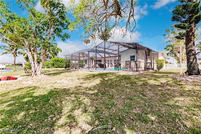 view of yard featuring a patio area, a swimming pool, and glass enclosure