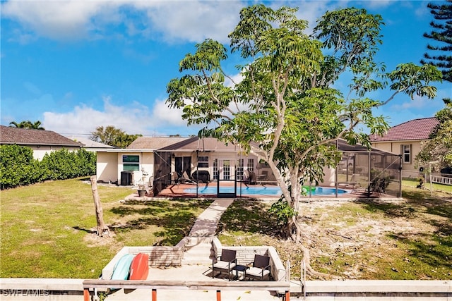 back of property featuring cooling unit, a patio area, a lawn, and glass enclosure