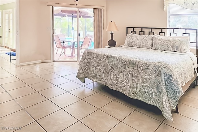 bedroom with access to outside and light tile patterned floors