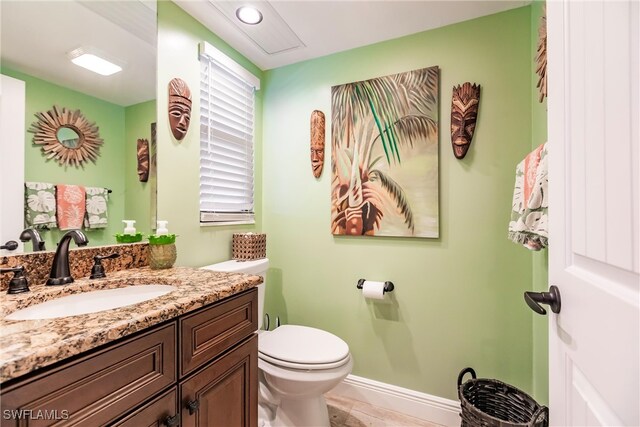 bathroom featuring vanity and toilet