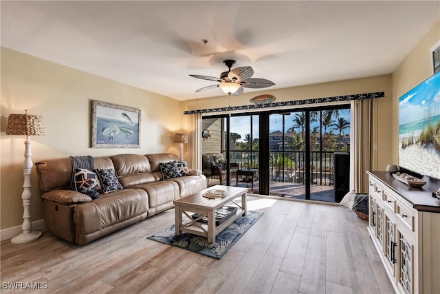 living room featuring light hardwood / wood-style floors and ceiling fan