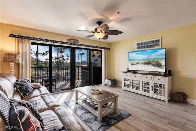 living room with light wood-type flooring and ceiling fan