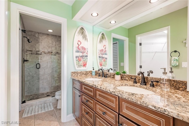 bathroom with vanity, tile patterned flooring, toilet, and an enclosed shower