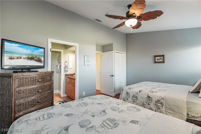 bedroom with a closet, ensuite bath, and ceiling fan