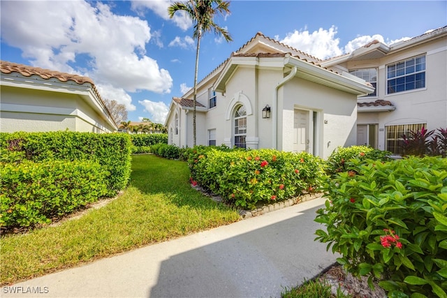 view of property exterior with a lawn