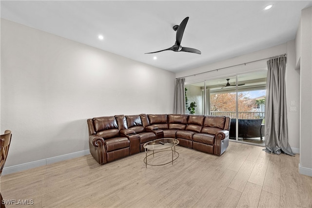 living room with ceiling fan and light wood-type flooring