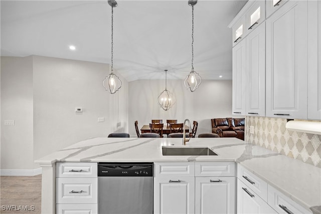 kitchen featuring dishwasher, light hardwood / wood-style flooring, sink, decorative light fixtures, and white cabinetry