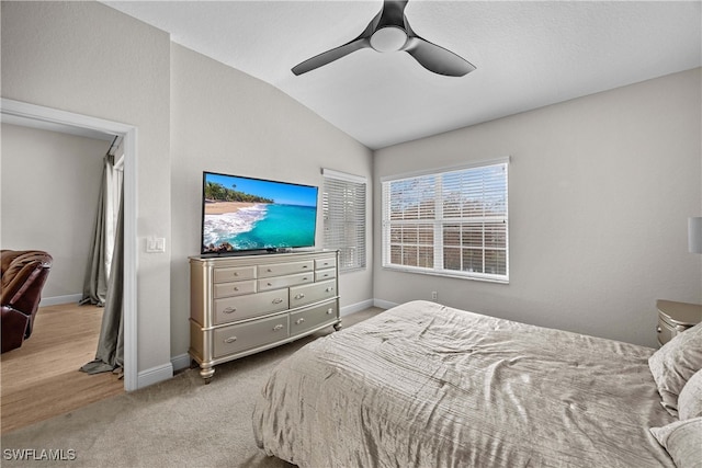 carpeted bedroom with lofted ceiling and ceiling fan