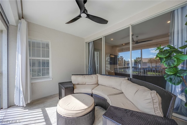 sunroom with ceiling fan