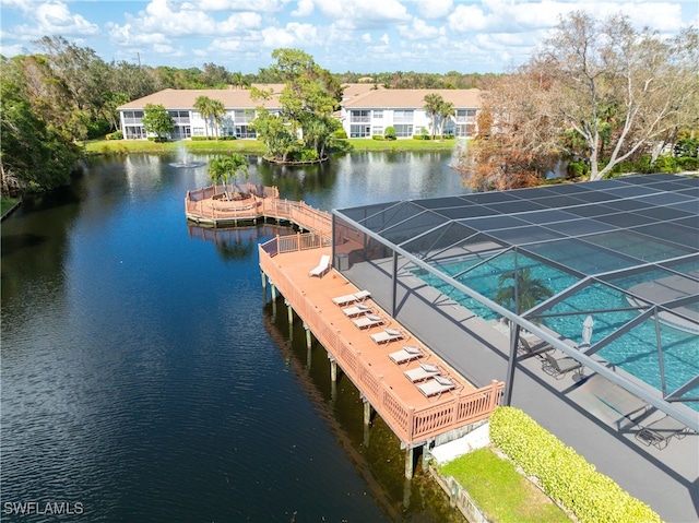 dock area with a lanai and a water view