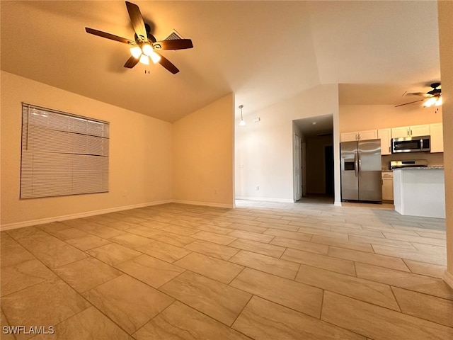 unfurnished living room with ceiling fan and vaulted ceiling