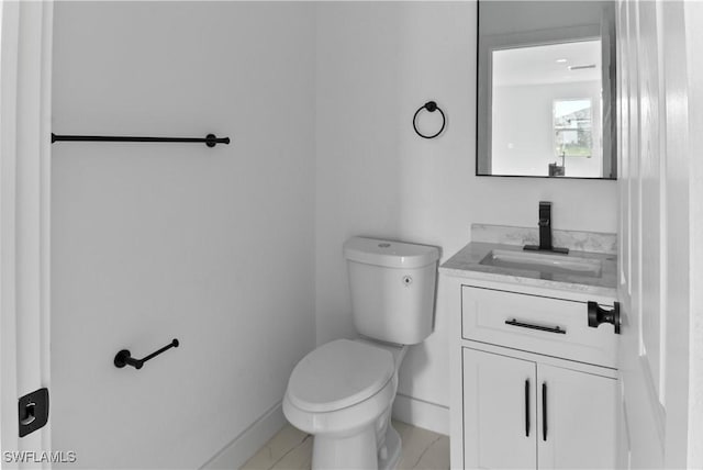 bathroom featuring toilet, tile patterned flooring, and vanity