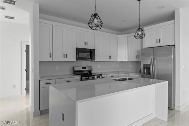 kitchen featuring decorative light fixtures, a kitchen island, sink, white cabinetry, and stainless steel appliances