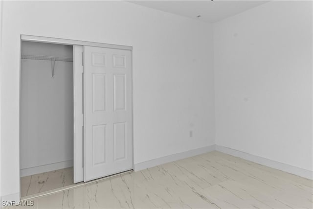 unfurnished bedroom featuring a closet