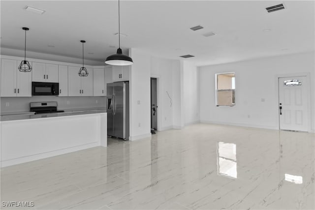 kitchen with hanging light fixtures, white cabinets, and appliances with stainless steel finishes