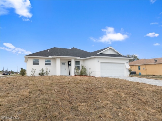 ranch-style house featuring a front yard and a garage