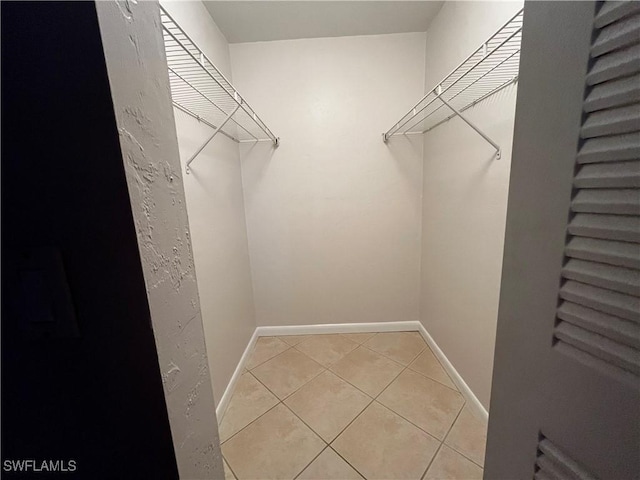 spacious closet with light tile patterned floors