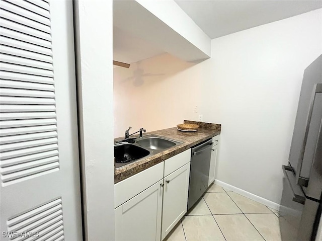 kitchen featuring white cabinetry, sink, stainless steel dishwasher, and light tile patterned floors