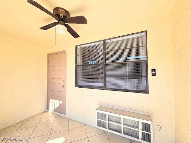 exterior space featuring light tile patterned flooring and ceiling fan