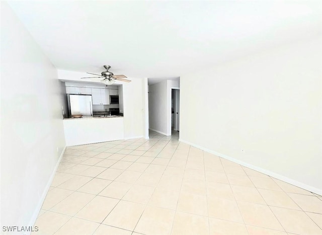 unfurnished living room with ceiling fan and light tile patterned flooring