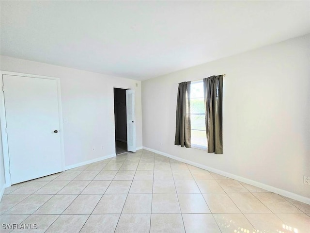 spare room with light tile patterned floors