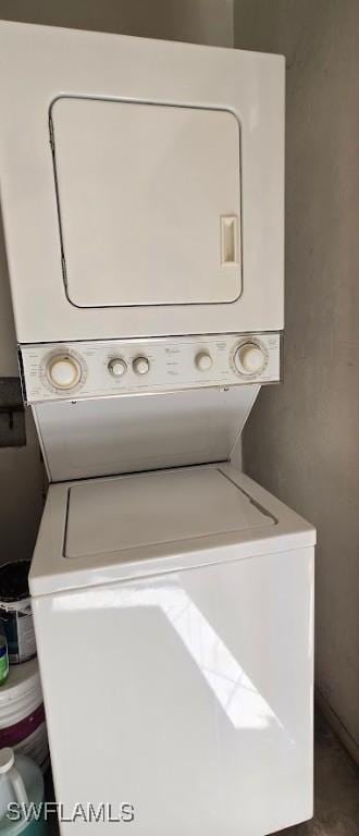 clothes washing area featuring stacked washer / drying machine