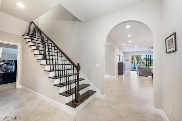 staircase featuring washer / clothes dryer, tile patterned flooring, and ceiling fan