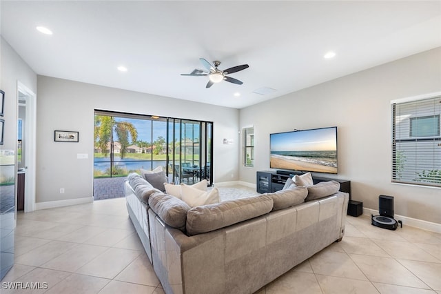 living room featuring ceiling fan and light tile patterned floors