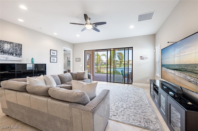 living room with ceiling fan and light tile patterned floors