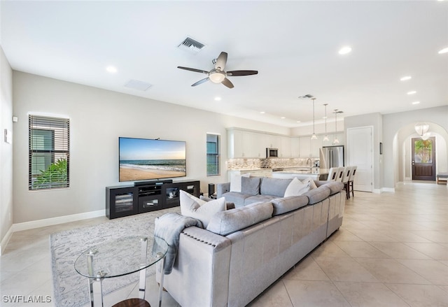 tiled living room featuring ceiling fan