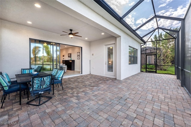 sunroom / solarium with ceiling fan and a healthy amount of sunlight