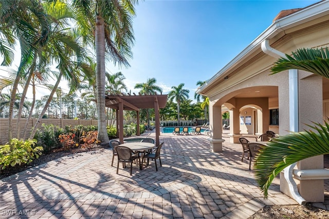 view of patio / terrace featuring a pergola and a fenced in pool