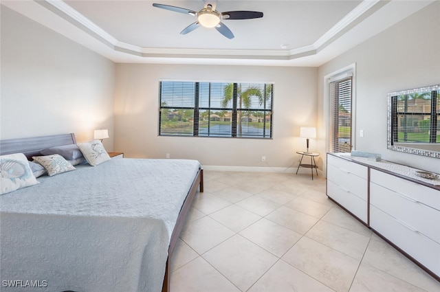 bedroom with ornamental molding, a raised ceiling, and light tile patterned floors