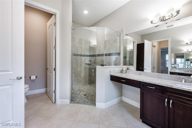 bathroom featuring vanity, tile patterned flooring, toilet, and walk in shower