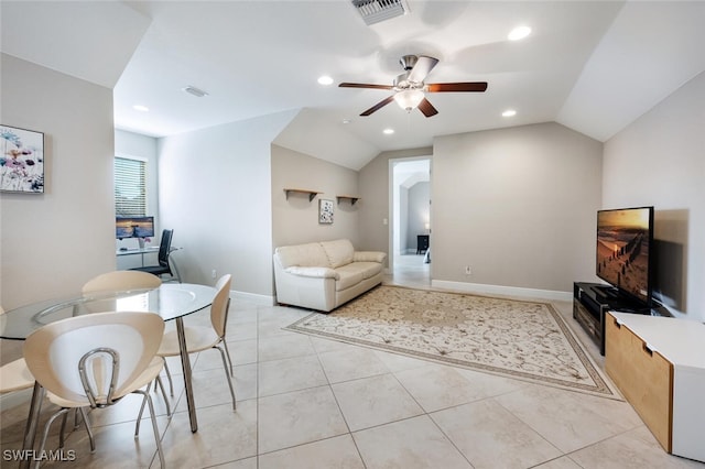 living room featuring light tile patterned floors, vaulted ceiling, and ceiling fan