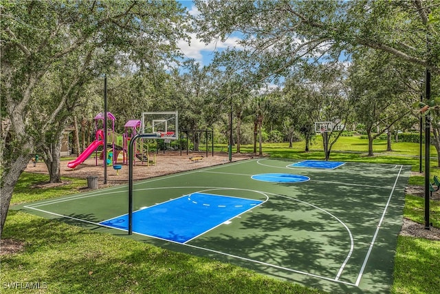 view of sport court with a lawn and a playground